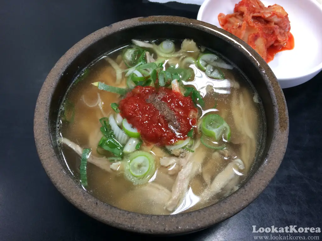 Dakgomtang at Darak Two in Hongdae, clear chicken soup with shredded chicken, green onions and dadaegi chili paste, served with kimchi