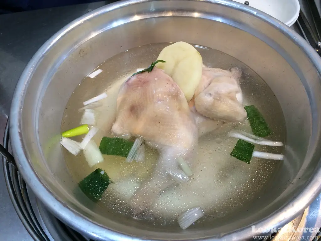 Korean Dakhanmari chicken soup with potatoes and green onions in a large metal pot