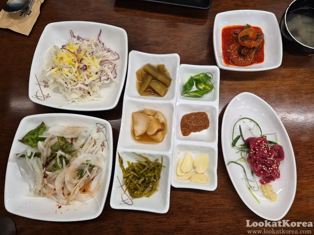 Side dishes at a Hanwoo restaurant served without lettuce wraps, including beef tartare